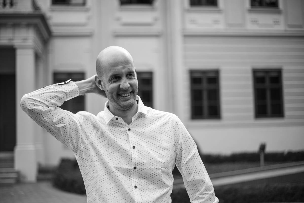 man in white dress shirt smiling