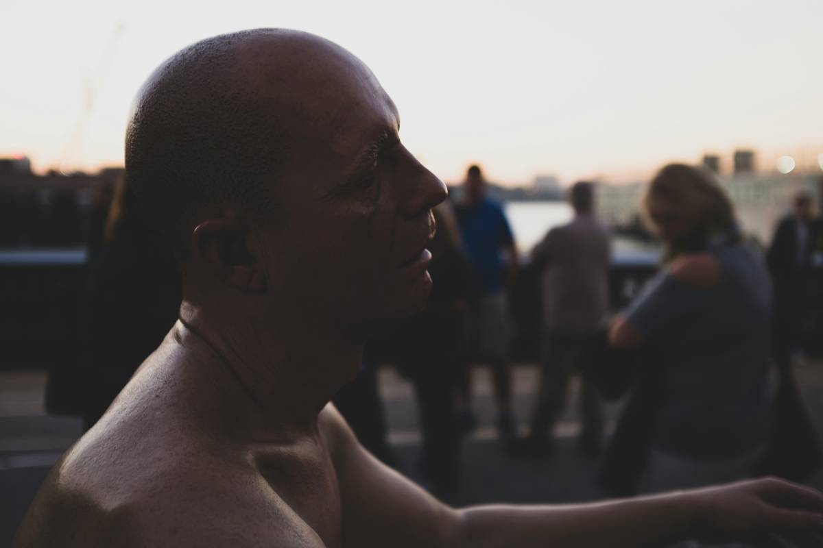 topless man by people during daytime